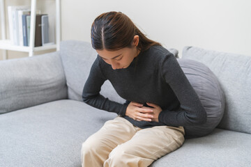 Flatulence ulcer, asian young woman, girl hands in belly, stomach pain from food poisoning,...