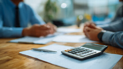 Fototapeta premium Business professionals discussing finance with calculator and documents
