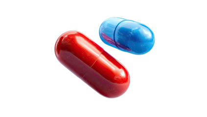 Close-up of two colorful capsules, red and blue, isolated on black background, medical concept