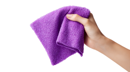 Hand holding a plush purple microfiber cloth for cleaning or dusting surfaces, ideal for household chores and hygiene promotion.