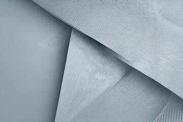 Abstract pale gray layered shapes with textured surfaces and angled perspective