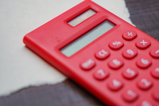 Red Calculator on Torn Paper