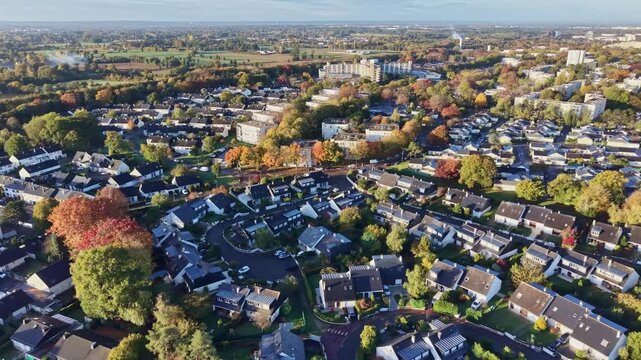 Aerial drone view of Le Blosne district in Rennes. Features residential houses and apartment buildings surrounded by colorful autumn trees. Ideal for real estate and city life concepts, France