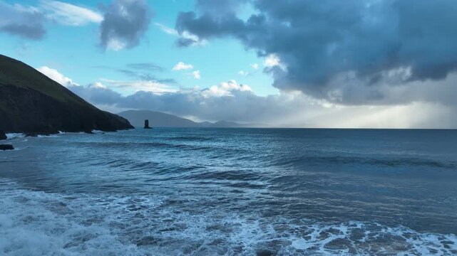 Wild Ireland Kinnard beach Dingle Kerry drone flying slowly over waves and views of Kenmare Bay winter evening