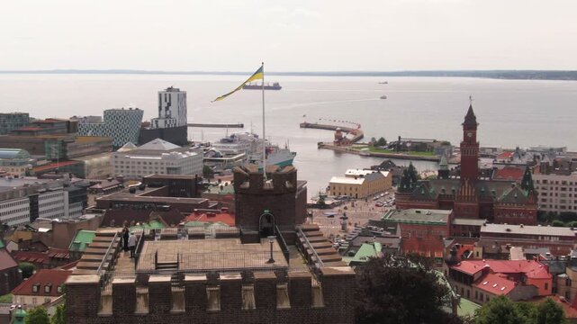 Tourists enjoying the view from the rooftop terrace of Karnan tower looking towards the harbor.