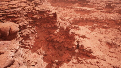 Obraz premium Breathtaking red rock formations dominate the landscape, showcasing unique textures and depths. Sunlight casts shadows across the rugged terrain, creating a mesmerizing effect.