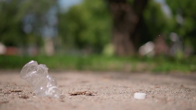 Man Discards Bottle, Person Using Shoe To Crush, Individual Intentionally Smashing Plastic Bottle Outdoors, Person Showing Responsibility By Crushing And Discarding Trash Responsibly Outside