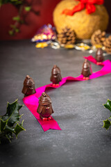 Chocolate penguins on a table with Christmas decorations
