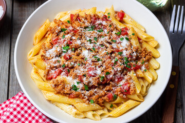 Pasta with bolognese sauce and cheese. Italian cuisine. Traditional recipe.