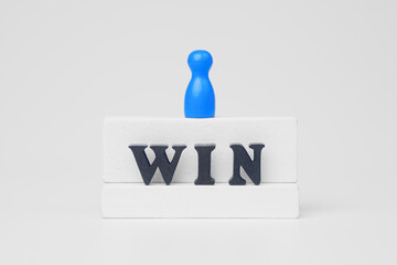 Success and achievement concept with wooden figure standing on win