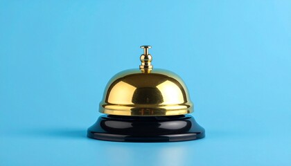 Golden service bell on black base against light blue background, minimalist product photography, glossy metal surface, soft studio lighting, clean composition, sharp focus