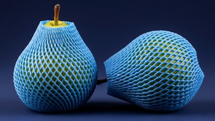 Two pears wrapped in blue netting on dark background fruit packaging protection