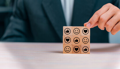 Social media engagement, Digital marketing concept. Placing the wooden cube blocks with emoticons, creating social media platforms to build relationships and drive sales. Sharing customer experiences.