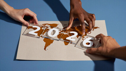 Hands assembling 2026 global future concept
