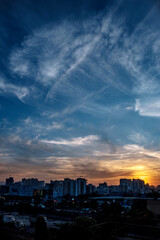 Fototapeta premium Evening scene with lit up and silhouetted buildings against a colourful evening sky at Pune India.