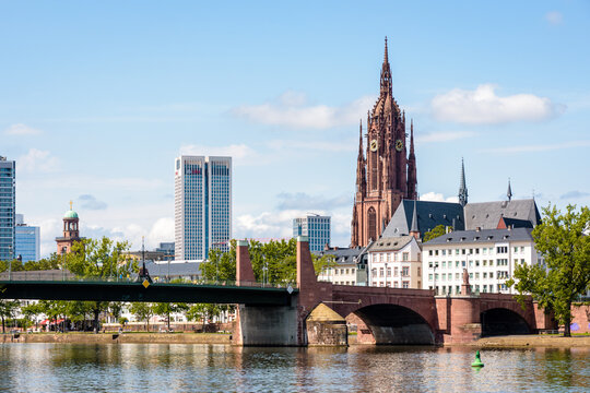 Frankfurt am Main, Germany - August 17, 2023: The bell tower of Frankfurt Cathedral (Imperial Cathedral of Saint Bartholomew) overlooks the Alte Br&uuml;cke, the old stone bridge over the river Main.