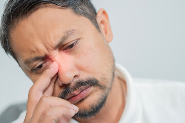 Obraz premium Man, nose and sinus pain with closeup for health, inflammation and sinusitis by allergy.