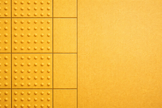 Yellow tactile paving texture background with clean copy space