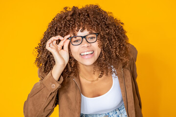 beautiful young woman showing her glasses isolated on background