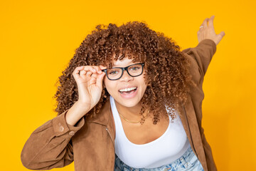 beautiful young woman showing her glasses isolated on background