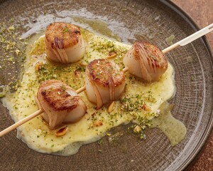 Scallop Skewer on Plate with Puree and Pistachios
