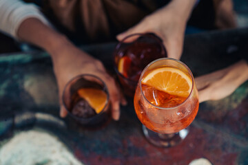 Overhead view of cocktails and hands at urban social gathering