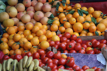 Colorful fresh fruits and vegetables at outdoor market stall