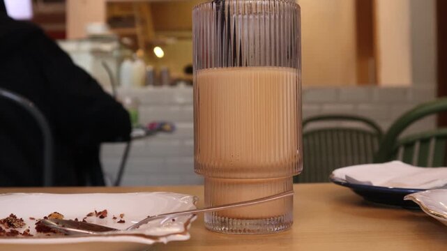drinks on a table with a cafe in the background.