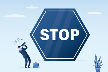 Tiny businessman uses binoculars and looking on giant stop sign. Obstacles, barriers, restriction and stereotypes. Ban, warning or danger situation