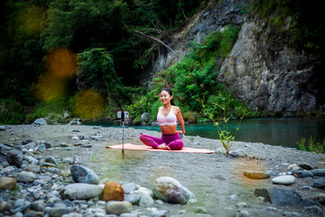 Smiling Japanese Yoga Instructor Recording Online Exercise Video Outdoors with Smartphone