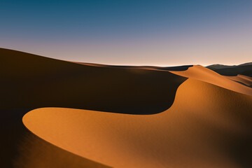 An artistic view of sand dunes showcasing flowing shapes and warm orange tones contrasted against darker shadows.