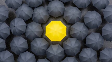 A lone yellow geometric shape standing out among numerous grey shapes in a crowded arrangement viewed from directly above