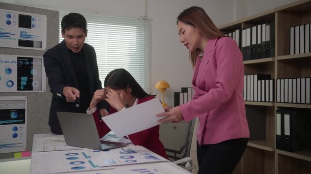 Stressed asian employee receiving negative feedback and criticism from an angry manager and boss. Toxic workplace and professional burnout