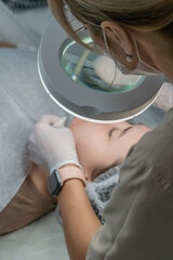 Dermatologist Facial Treatment Clinic Skincare: Professional skin examination and treatment during a clinic visit.