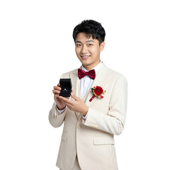 Young Asian man in cream suit holding ring box