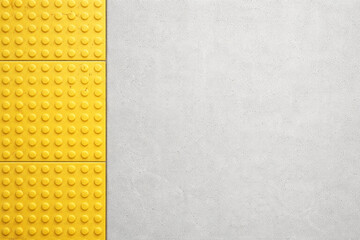 Yellow tactile paving on station platform with copy space