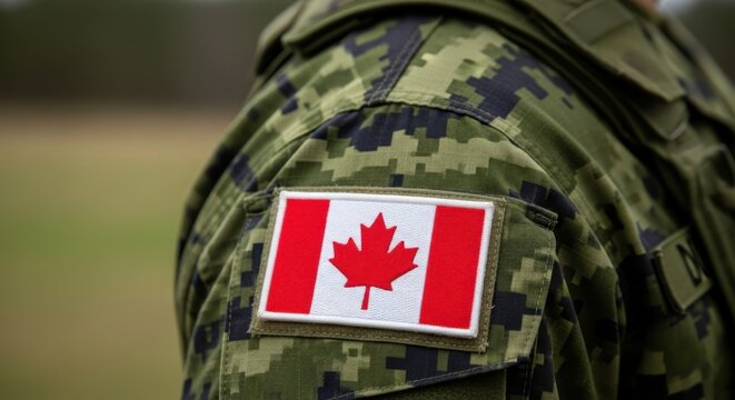 Canadian soldier wearing camouflage uniform with national flag patch on shoulder