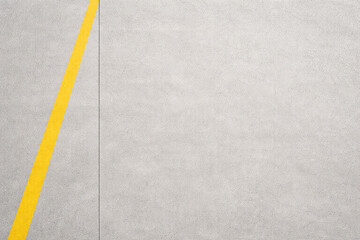 Clean airport tarmac concrete with yellow guidance line and copy space