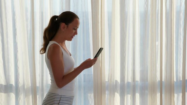 Woman hold smartphone in hand against face and talk to, discontent emotions. Lady talk and listen, try to explain, gesticulate by free hand