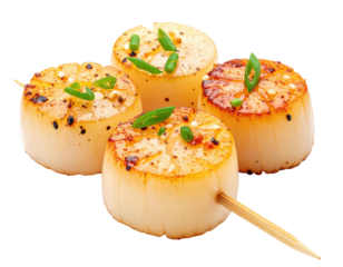 Four perfectly seared scallops, garnished with green onions and seasoning