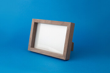 Wooden desktop photo frame modern style, picture frame on blue background