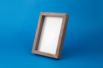 Wooden desktop photo frame modern style, picture frame on blue background