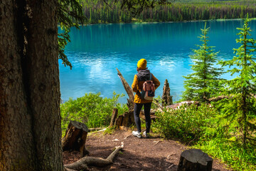 Hiker admiring stunning turquoise maligne lake in jasper national park