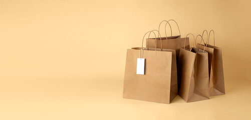 Banner for paper shopping bag with price tag isolated on beige background