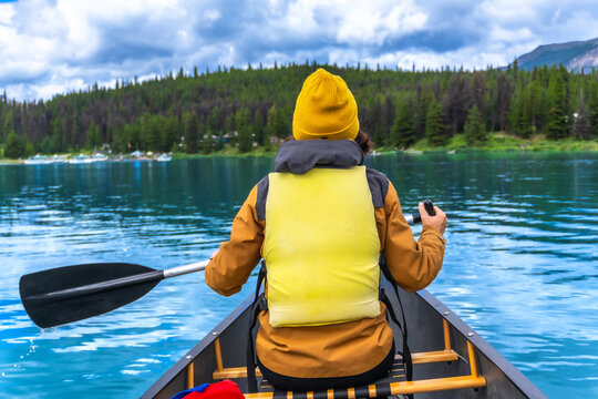 Tourist canoeing in maligne lake, jasper national park, alberta, canada