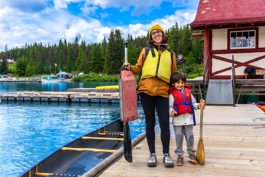 Mother and son preparing for canoe trip on maligne lake, jasper national park