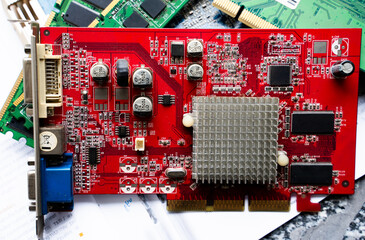 Red graphics card with electronic components on circuit board