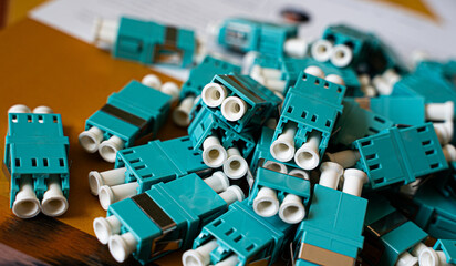 Fiber optic connectors and adapters used in data communication networks. Telecommunications technology concept.