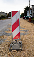 Roadwork warning sign placed on a city street. Traffic safety and infrastructure maintenance concept.