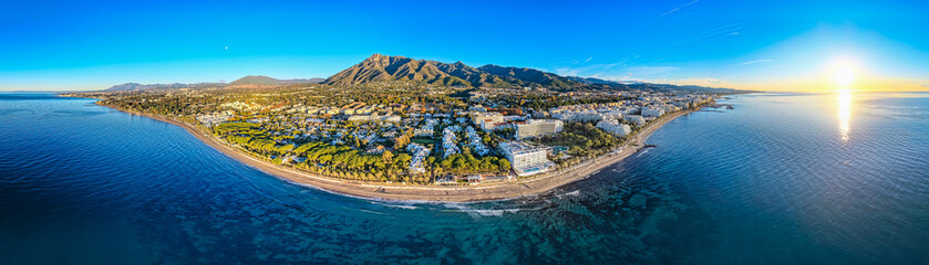 Luxury Living at Dawn: Cinematic 4K Aerial of Marbella&rsquo;s Golden Mile, Featuring Exclusive Beachfront Resorts, the Paseo Mar&iacute;timo, and La Concha Mountain, Costa del Sol, Spain